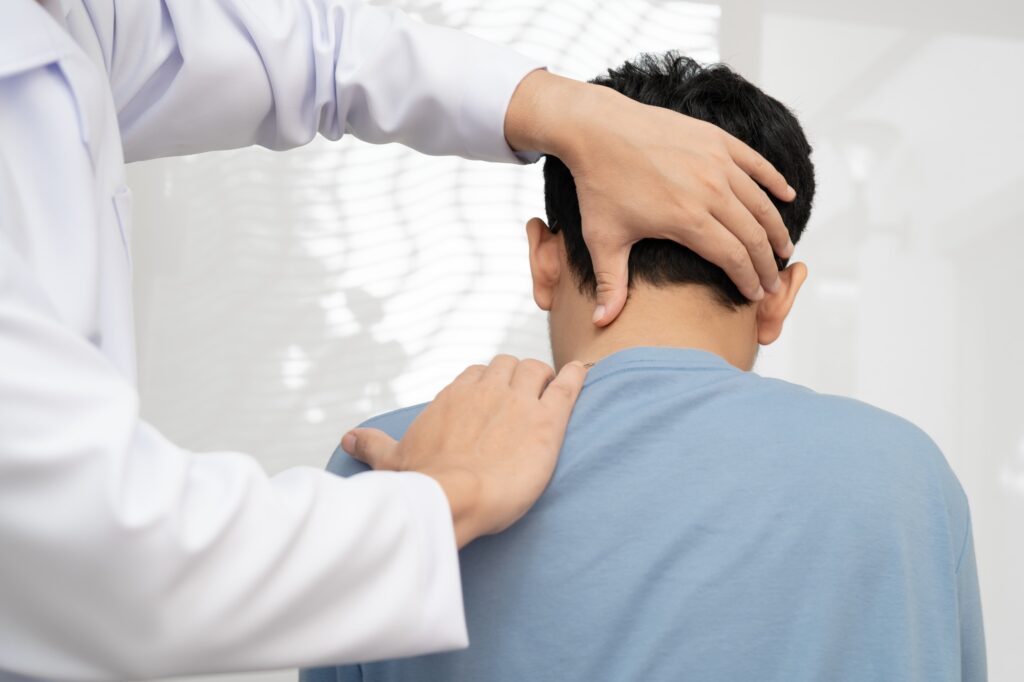 Physical therapy, Asian therapist doctor treat perform pain young man in hospital.